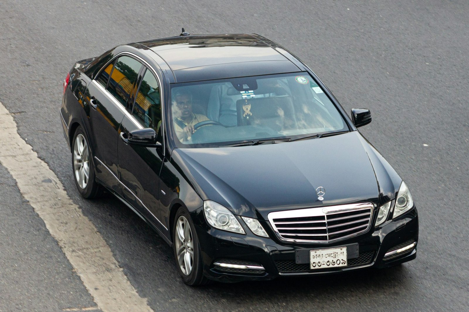 Black Mercedes-Benz E-Class executive sedan on the road