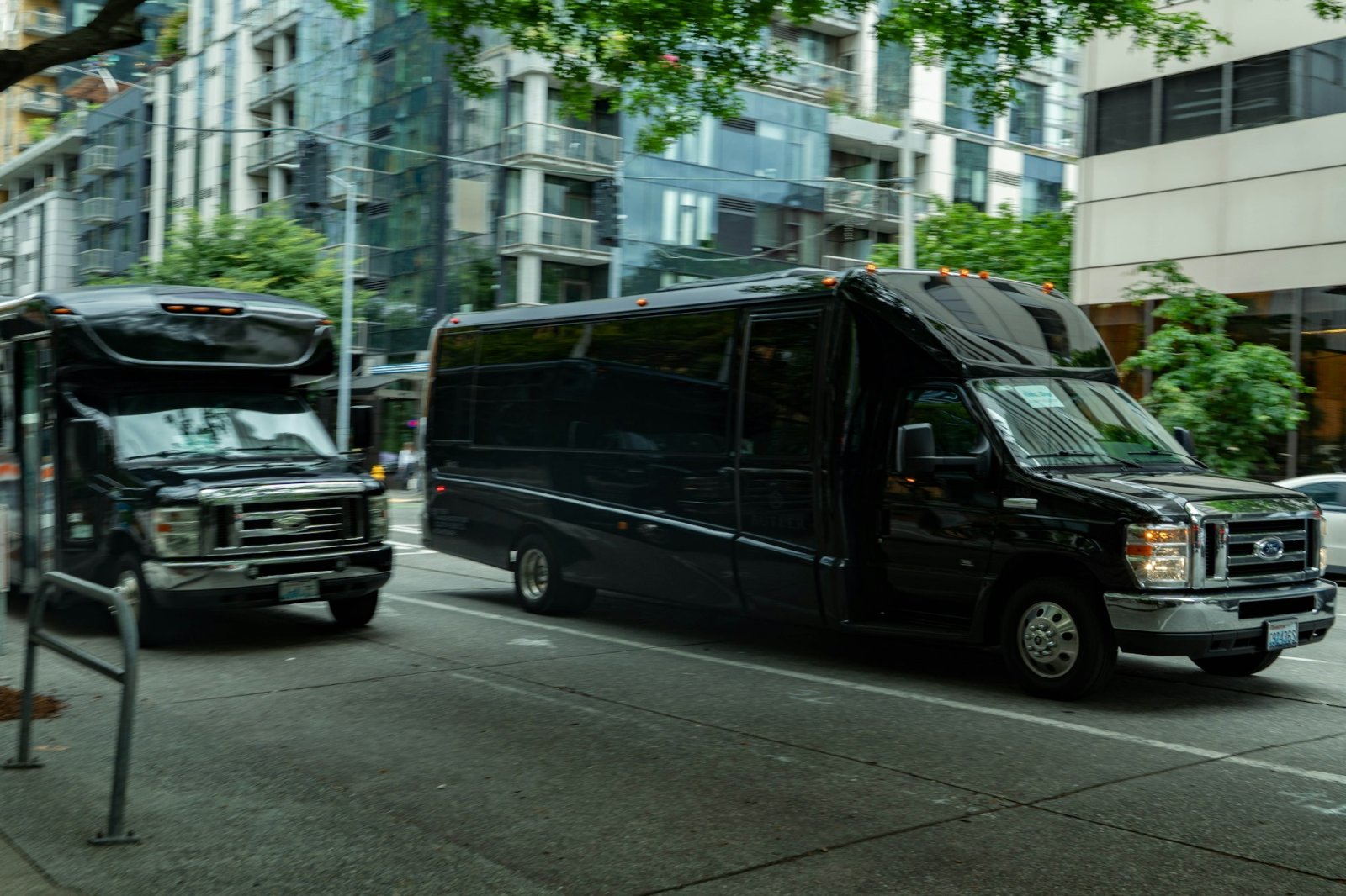 Black limousine buses parked on a downtown Seattle street