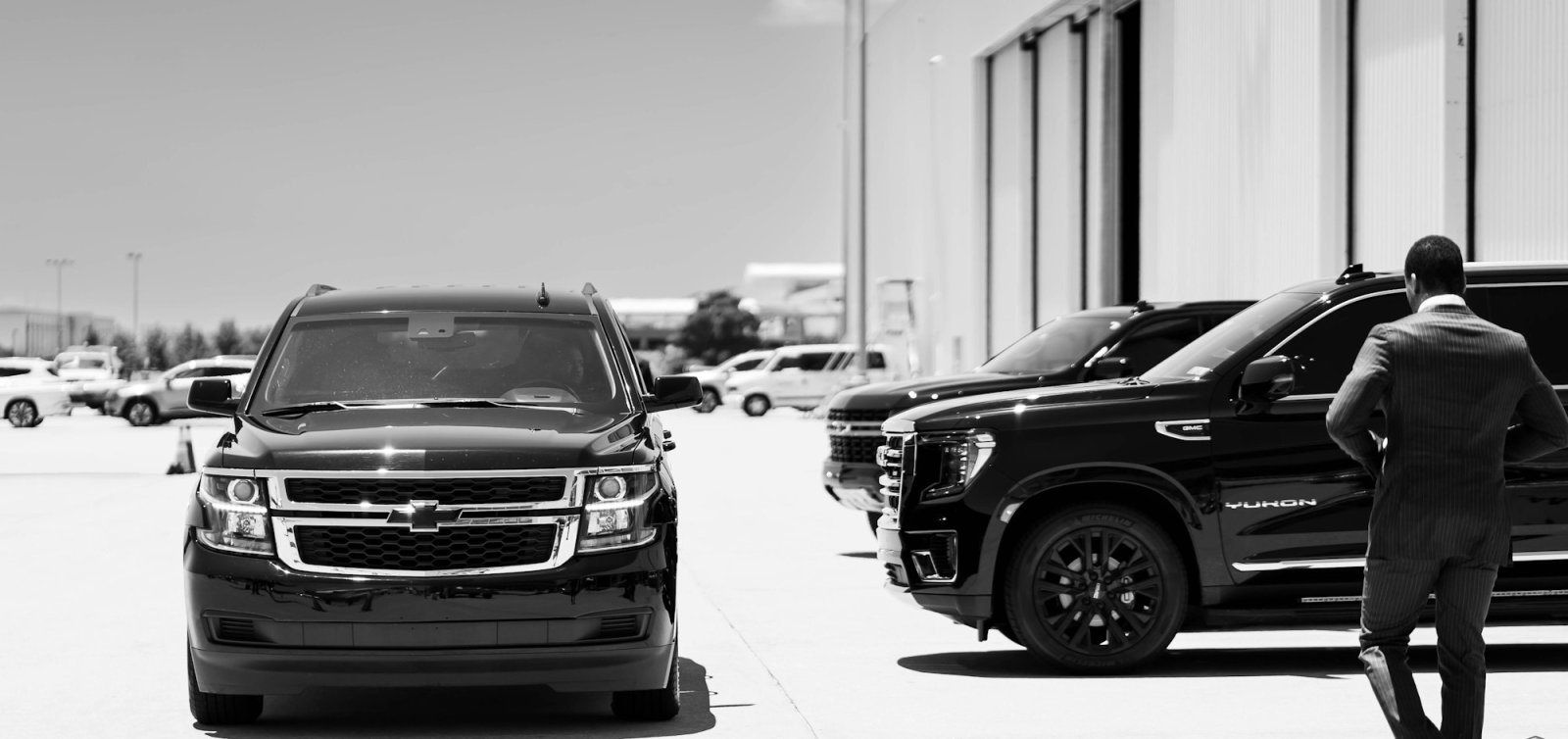 Black Chevrolet Suburban and GMC Yukon SUVs ready for pickup