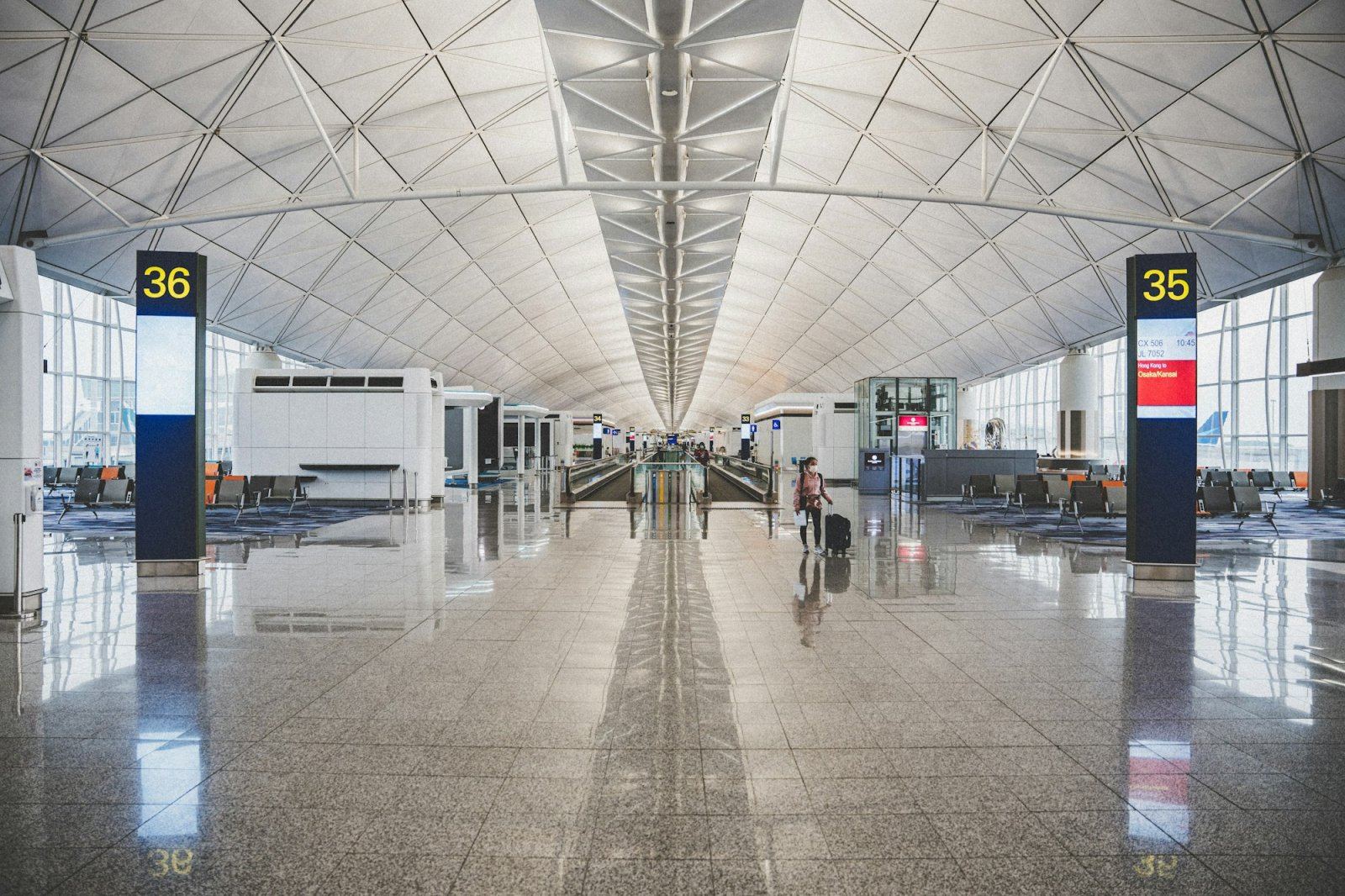 Traveller walking through a bright airport terminal