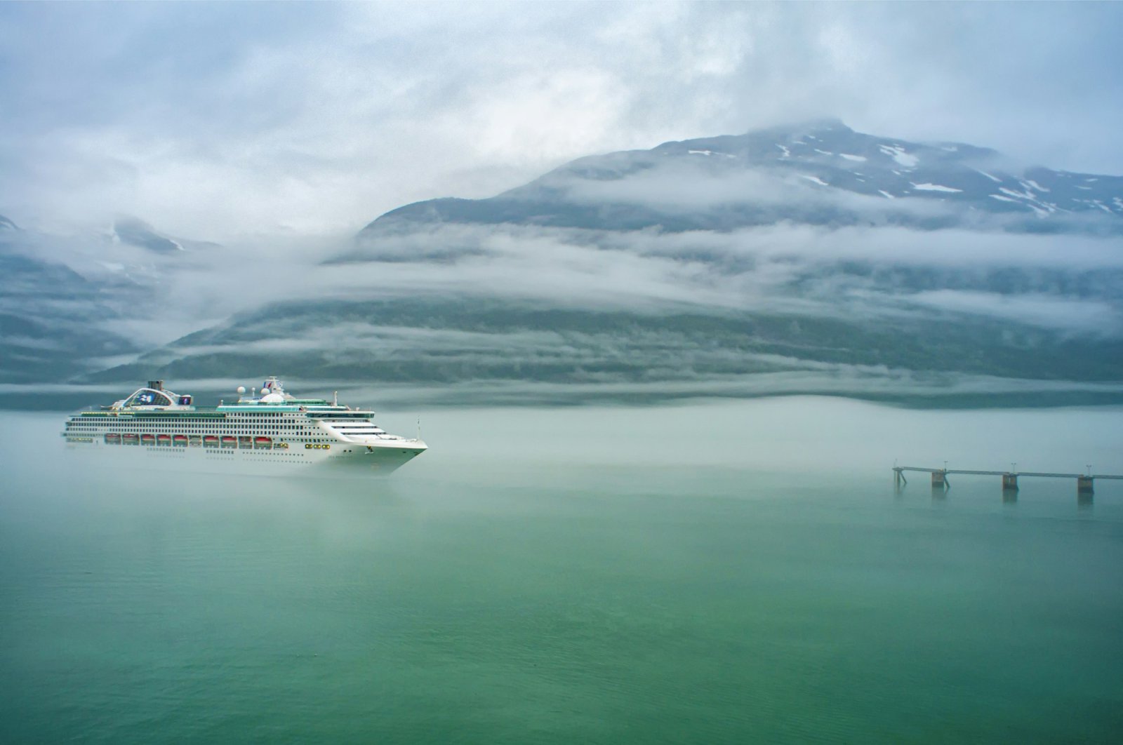 Cruise ship in a misty Alaskan fjord