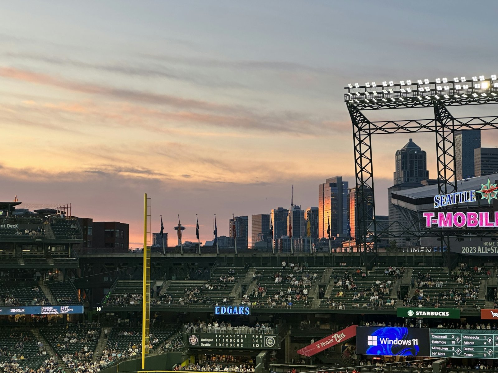 Seattle ballpark lights and skyline at dusk