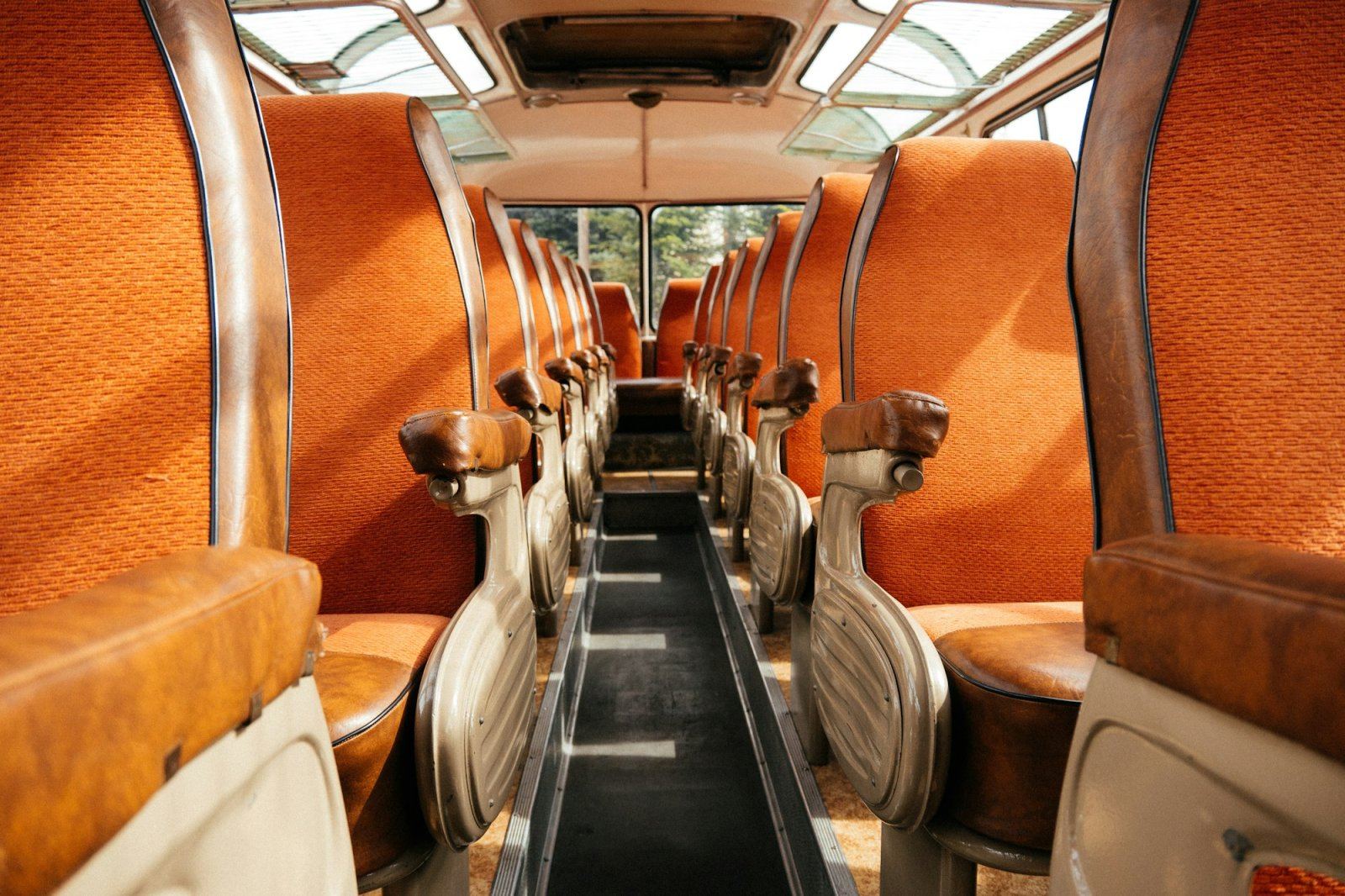 Illuminated interior of a limousine bus with leather seating