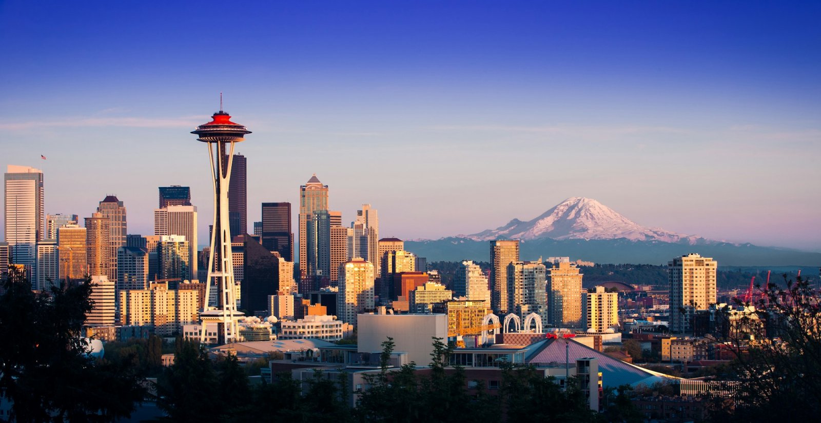 Seattle skyline and the Space Needle with Mount Rainier at dusk